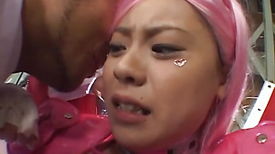 Eccentric Asian hottie in pink costume in a hardcore action